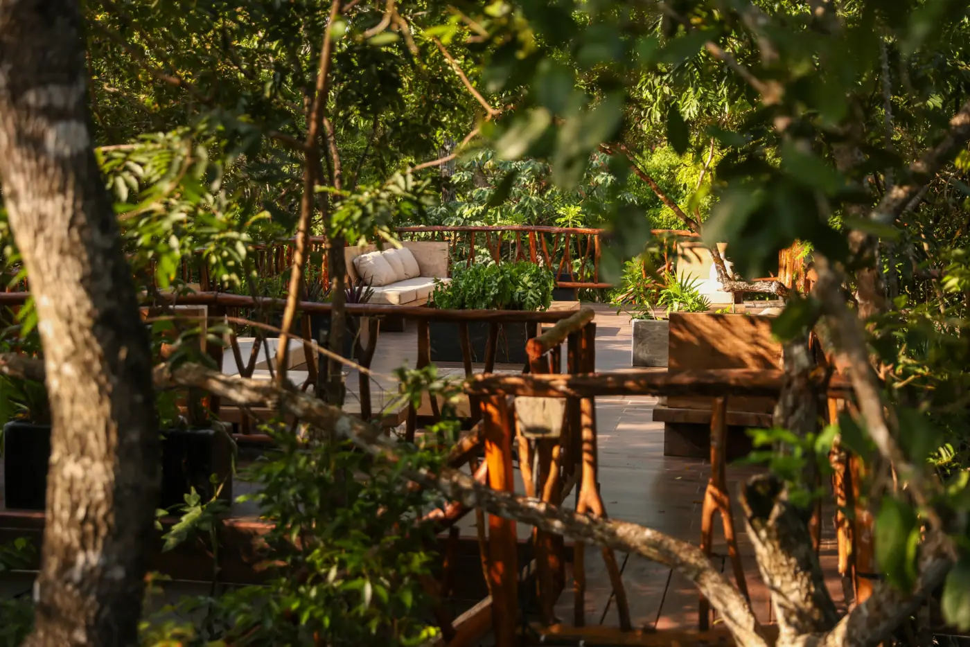 A shaded lounge deck tucked into the jungle canopy at Kaaba Luum